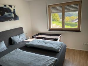 a bedroom with two beds and a window at Fewo Grafenblick in Balingen