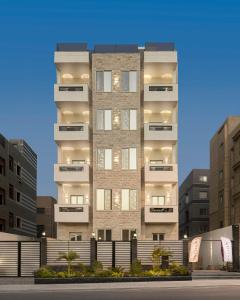a tall building with a fence in front of it at Rivana Residence New Cairo - Pool & GYM Access in Cairo