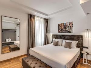 a bedroom with a large bed and a mirror at Mercure Roma Centro Termini in Rome +67 photos