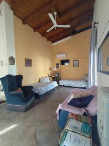 a living room with a couch and a ceiling fan at Near AirportAnd metropolitan Penelopi Cozy Home in Artemida