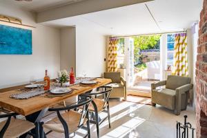 a dining room with a wooden table and chairs at Waterhen Cottage in Docking