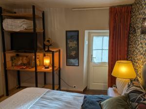 a bedroom with a bunk bed and a lamp at Gourmandise in Coutances