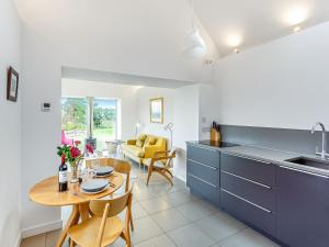 a kitchen and dining room with a table and a kitchen and a dining room at Taigh Glas in Big Sand