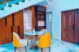 una sala da pranzo con un tavolo e sedie gialle di Best Terrace Homes a Oshogbo