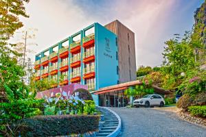 a hotel building with flowers in front of it at Yangshuo Courtyard Hotel - An all-English team by the Li River in Yangshuo