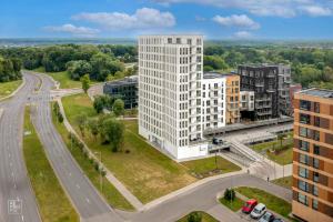 an aerial view of a tall white building next to a road at Bright 2BR with Private EV Parking, workspace, AC in Kaunas