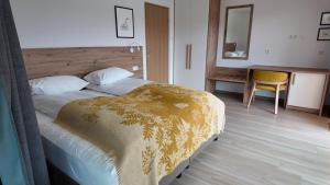 a bedroom with a bed and a desk with a mirror at Hotel 1001 Nott in Egilsstadir