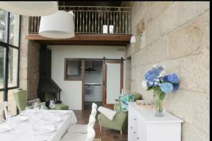 a dining room with white tables and blue flowers at Villa - 5 Bedrooms with WiFi - 7841 in A Estrada