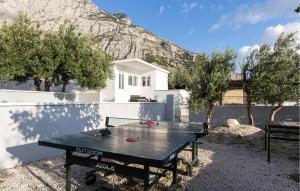 a ping pong table in front of a house at Amazing Home In Makarska in Veliko Brdo