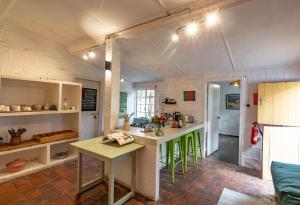 a kitchen with a green island in a room at Sanctuary Farm House 5-bedroom Lodge In Wildlife in Naivasha