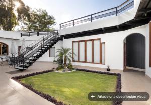 a house with a lawn in front of it at Vita House in Quito