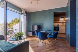a kitchen and living room with a table and chairs at Palazzo Pastura B&B and Apartments in Catania