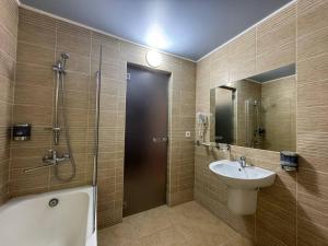a bathroom with a shower and a sink and a tub at Готель «Северинівка» in Severynivka +18 photos