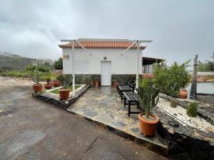 een huis met een bankje en potplanten bij La Era in La Concepción +2 foto's