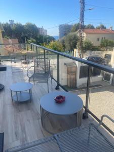 a balcony with two tables and chairs on a balcony at T3 Cros De Cagnes Bord De plage in Cagnes-sur-Mer +4 photos