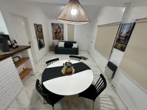 een eetkamer met een witte tafel en stoelen bij COMPLEJO JONAS SALK - departamento de 1 dormitorio amoblado in San Francisco
