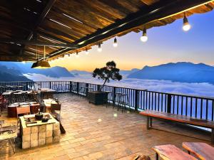 a patio with a view of the mountains at Hầu Thào Villa & Coffee in Sapa