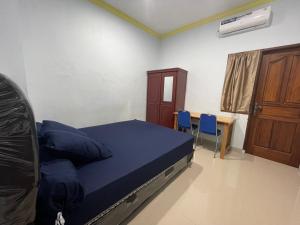 Ένα ή περισσότερα κρεβάτια σε δωμάτιο στο Blissful Executive Kost