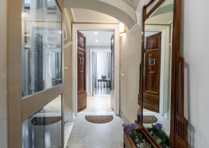 a hallway of a home with a door leading into a room at Palazzo Pastura B&B and Apartments in Catania +96 photos