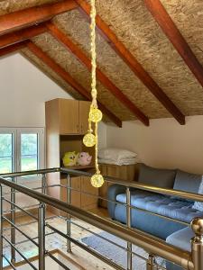 a living room with a blue couch and a ceiling at Dadula na Dunavu in Kovin