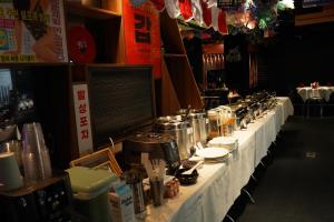 a long table with a white table cloth with pots and pans at THE STAR HOTEL 2 - Phú Mỹ Hưng, Hồ Chí Minh in Ho Chi Minh City +28 photos