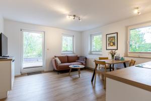 a living room with a couch and a table at Boddenräuber 3 in Ahrenshoop