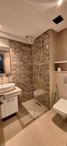 a bathroom with a shower and a sink at Appartement Le Guéliz,au centre de Marrakech, pool & fast WiFi in Marrakech