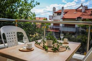 a table on a balcony with a view of a building at Özden Pansiyon in Burhaniye