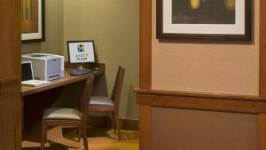 a room with a desk with a computer and chairs at Hyatt Place Phoenix-North in Phoenix