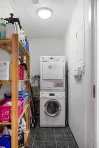 a laundry room with a washing machine and a washer at Fjellheim Kurs- og Misjonssenter in Tromsø