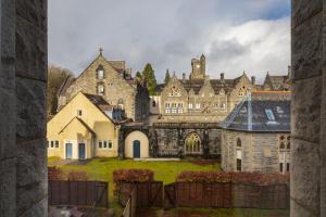 a large stone building with a yard in front of it at Abbey Church 20 in Fort Augustus