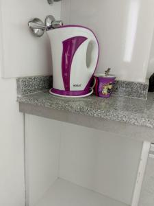 a purple and white pitcher sitting on a counter at EmBruHadas Violet in San Salvador de Jujuy