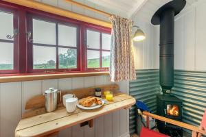 a room with a stove with a plate of food on a table at 1 Bed in Cowling oc-s30772 in Cowling +15 photos