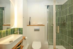 a bathroom with a shower and a toilet and a sink at Suite romantique avec Spa in La Celle-sous-Gouzon