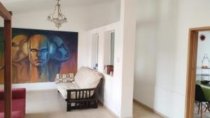 a living room with a painting on the wall at Casa Inspira in Neuquén