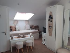 a bedroom with a bed and a table and stools at Villa Saint Barth in Gujan-Mestras