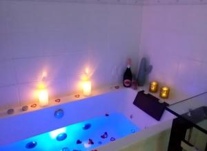 a bathroom with a tub with lights on it at Villa Saint Barth in Gujan-Mestras +38 photos