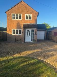 a brick house with a white door and a driveway at The Nook Holbeach town center 5 person 3 bed self catering in Holbeach