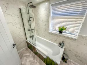 a bathroom with a shower and a sink at Ty Pentref by STAE-Homes in Porth
