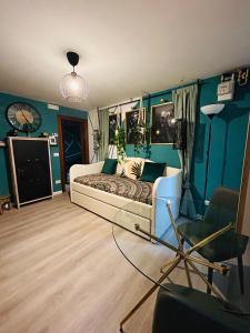 a living room with a bed and a chair at Family House di Genny e Nicola small suite in Chioggia