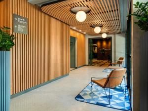 a hallway with a chair in a building at Novotel SP Jardins in Sao Paulo