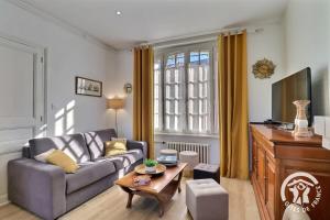 un soggiorno con un divano e un tavolo di Le safran a Dinard