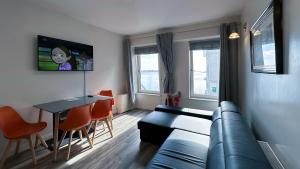 a living room with a couch and a table at KCM Urban Retreats in Cobh