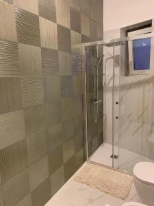 a bathroom with a shower and a toilet at I 4 Venti in Melendugno +60 photos