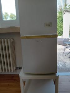 a refrigerator sitting on a table in a room at Sud e Sole in Arnesano