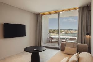 een woonkamer met een bank, een tv en een tafel bij Dayone Kilyos Hotel in Kilyos