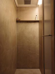 a bathroom with a shower with a shelf on the wall at Kaaimans Crest Sea-View Apartments - Great Brak River in Groot Brak Rivier