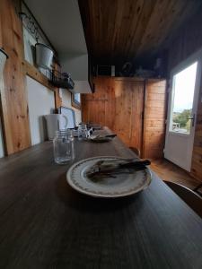 a wooden table with a plate on top of it at Tiny House LA TITITINY 