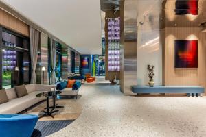 a lobby with a couch and a table and chairs at Holiday Inn Express Shanghai Changyang Road by IHG in Shanghai