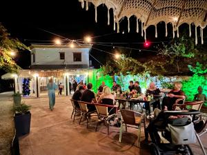 a group of people sitting at tables at a restaurant at night at Villa Malaga con Jacuzzi Piscina vallada Barbacoa By AndaraHolidays in Sayalonga +53 photos